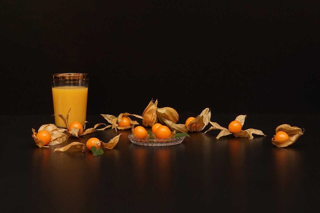 Oranges spread out with a glass of orange juice